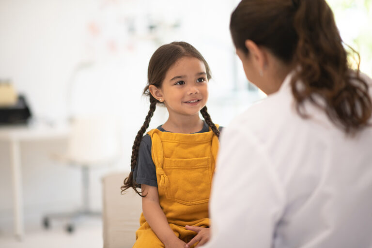Girl Receiving Check up with the Doctor stock photo