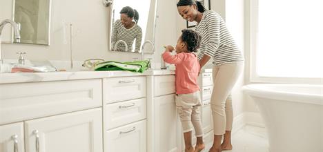 Healthy New Year parent helping child brush teeth (1)